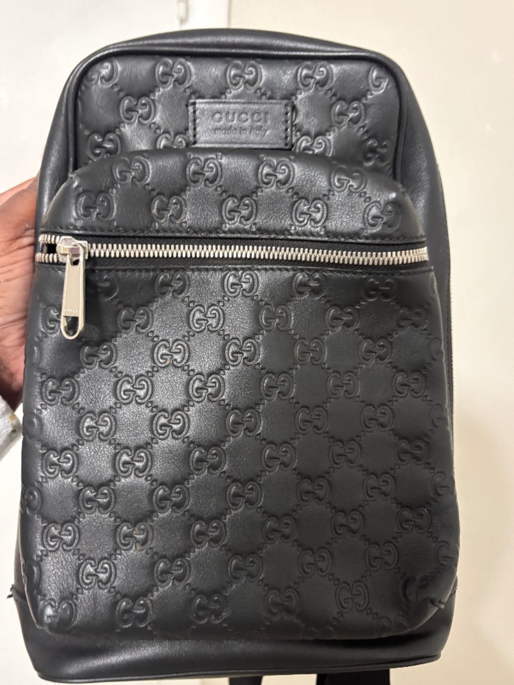Gucci Guccissima black leather sling backpack